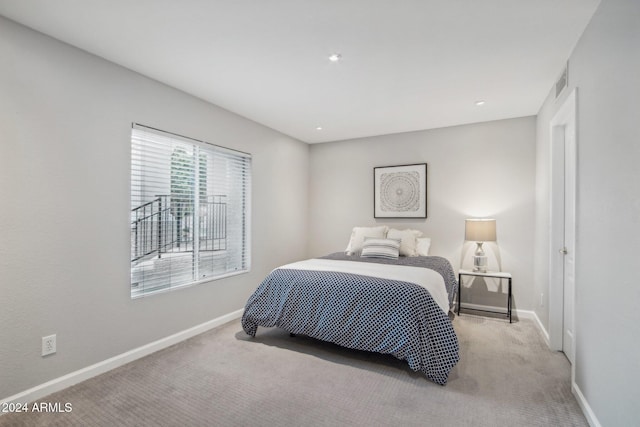 bedroom with light colored carpet