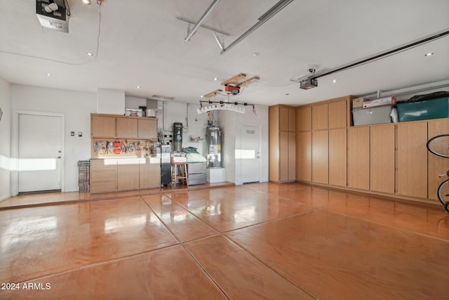 garage with gas water heater and a garage door opener