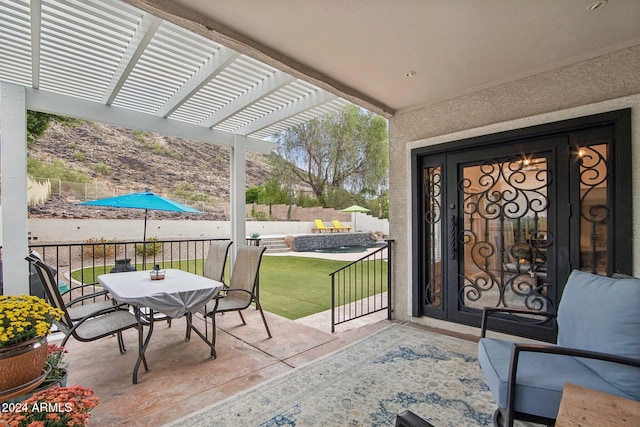 property entrance with a pergola, a patio area, and a lawn