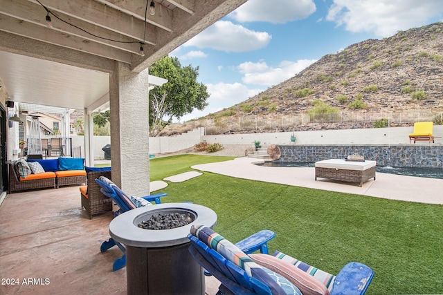 view of patio / terrace featuring a mountain view and an outdoor fire pit