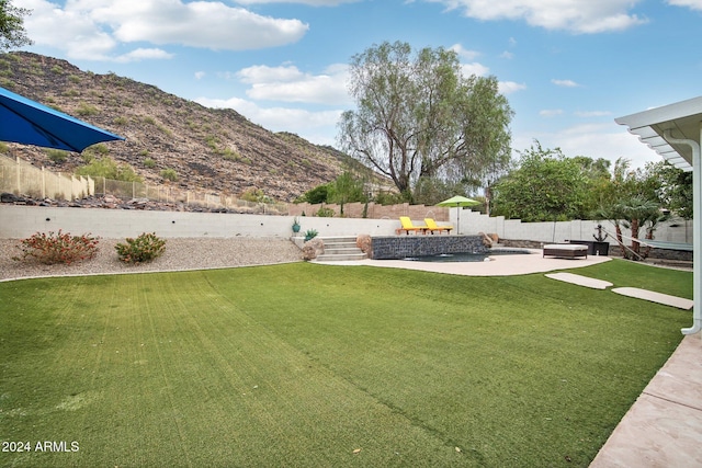 view of yard featuring a mountain view and a patio area