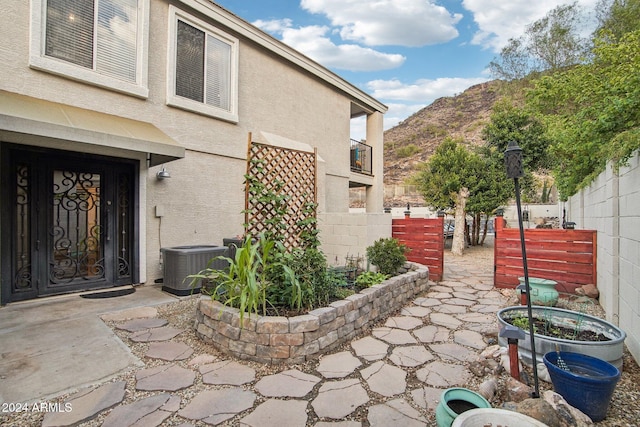 view of patio with a mountain view and cooling unit