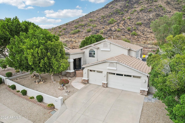 view of front of house featuring a mountain view and a garage