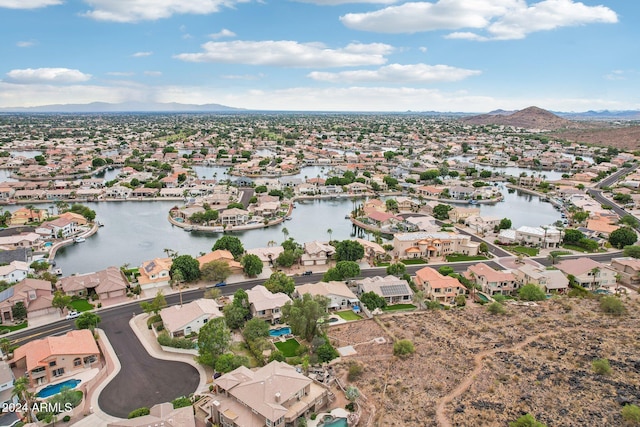 aerial view featuring a water and mountain view