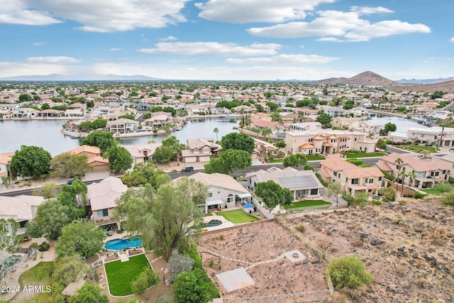 drone / aerial view featuring a water and mountain view