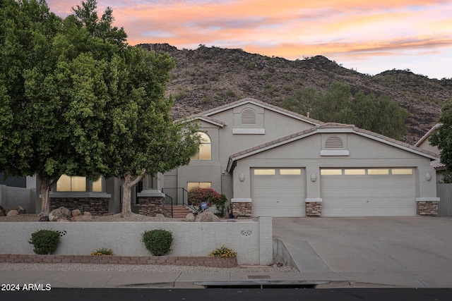 view of front of house featuring a mountain view and a garage