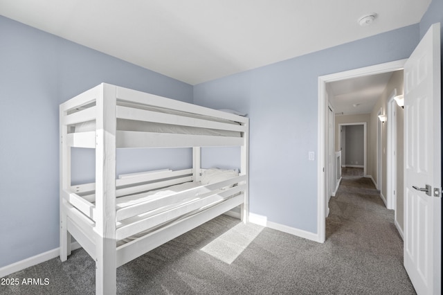 unfurnished bedroom featuring carpet and baseboards