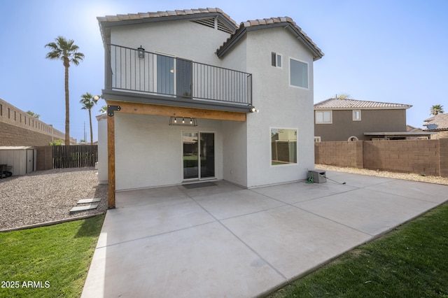 back of property with a patio, a fenced backyard, a balcony, and stucco siding