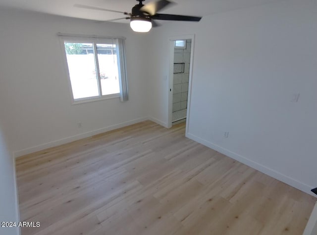 empty room with ceiling fan and light wood-type flooring