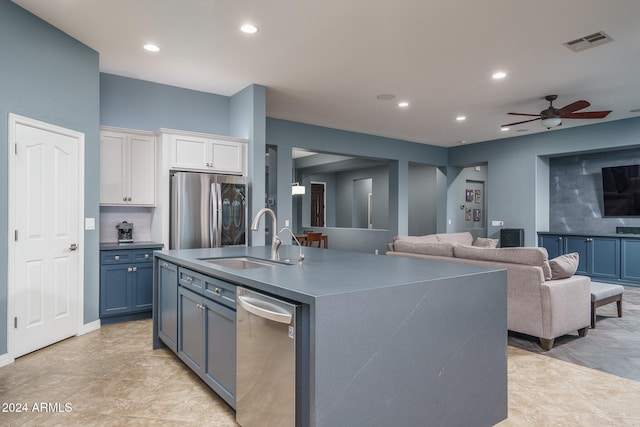 kitchen featuring sink, an island with sink, ceiling fan, white cabinetry, and appliances with stainless steel finishes