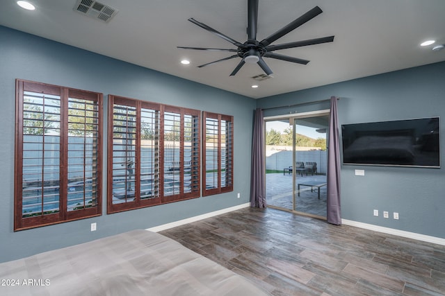 empty room with hardwood / wood-style floors and ceiling fan