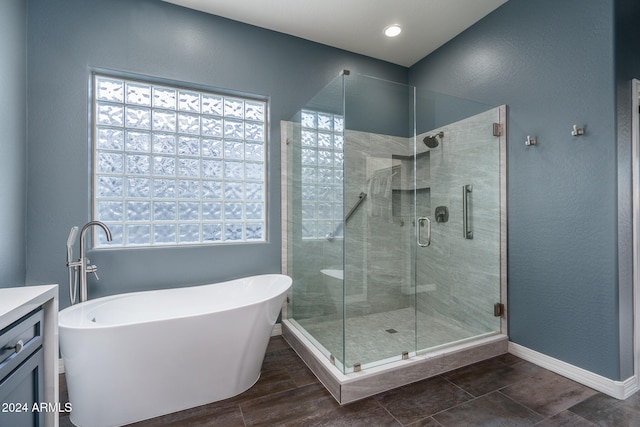 bathroom with hardwood / wood-style floors, vanity, and plus walk in shower