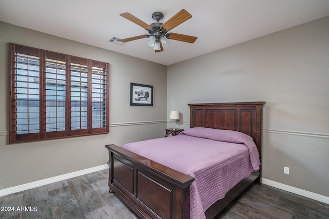 bedroom with ceiling fan and dark hardwood / wood-style flooring