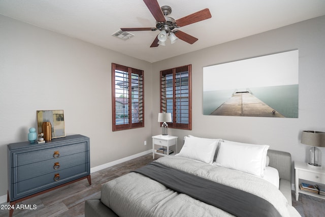 bedroom with dark wood-type flooring and ceiling fan