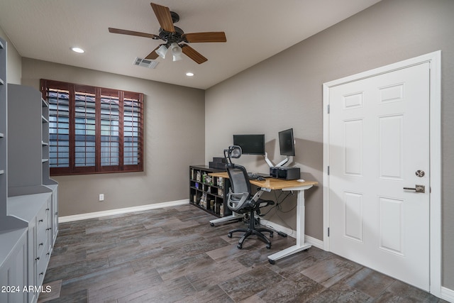 home office with ceiling fan and dark hardwood / wood-style floors