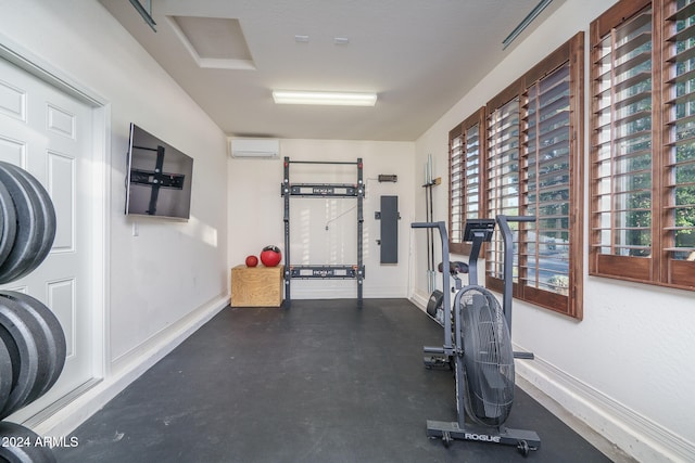 workout area with a wall mounted air conditioner