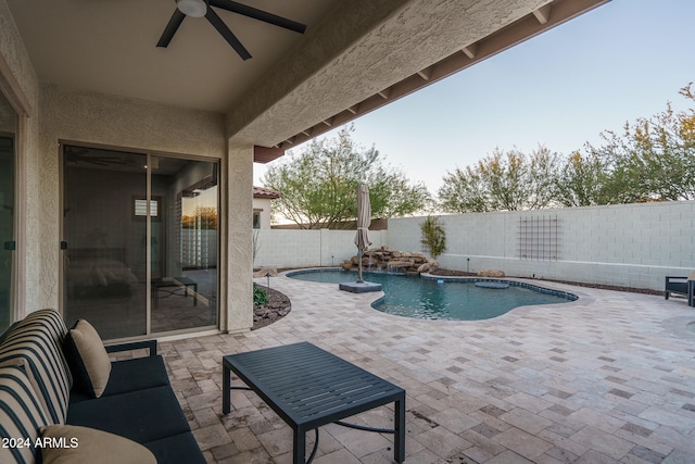 view of pool with a patio area, ceiling fan, and pool water feature