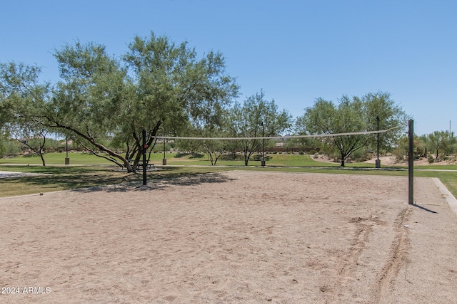 surrounding community with a yard and volleyball court