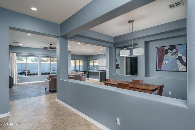 interior space with ceiling fan and light tile patterned floors