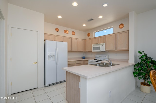 16354 W Labyrinth Ln, Surprise, AZ 85374 - kitchen featuring white appliances, light brown cabinets, a peninsula, light countertops, and light tile patterned flooring