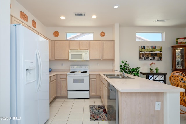 16354 W Labyrinth Ln, Surprise, AZ 85374 - kitchen with white appliances, light brown cabinetry, a peninsula, light countertops, and plenty of natural light