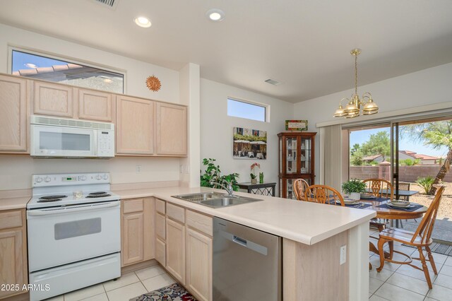 16354 W Labyrinth Ln, Surprise, AZ 85374 - kitchen with white appliances, light brown cabinets, a peninsula, a chandelier, and light countertops