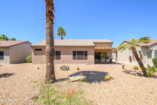 16354 W Labyrinth Ln, Surprise, AZ 85374 - rear view of house featuring stucco siding, a tiled roof, and a patio