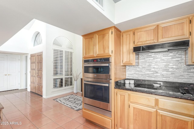 kitchen featuring black electric cooktop, dark stone counters, double oven, and backsplash