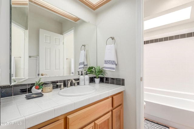 bathroom with vanity and a skylight