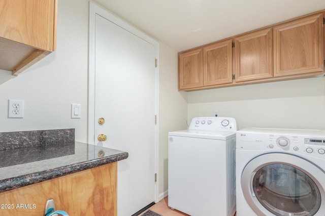 laundry area featuring cabinets and washer and clothes dryer