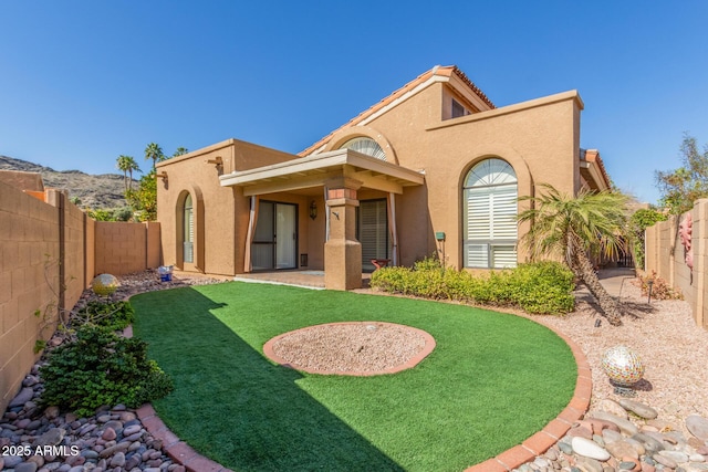 back of property featuring a yard and a patio