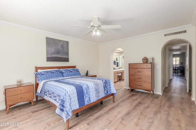 bedroom featuring crown molding, ceiling fan, wood-type flooring, and connected bathroom