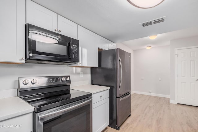 kitchen with stainless steel appliances, white cabinetry, and light countertops