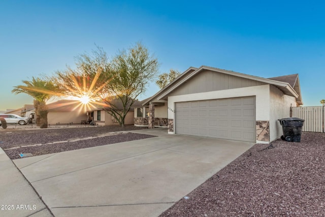 ranch-style house with a garage, concrete driveway, stucco siding, and fence