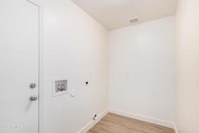 laundry area with electric dryer hookup, washer hookup, baseboards, light wood-type flooring, and hookup for a gas dryer