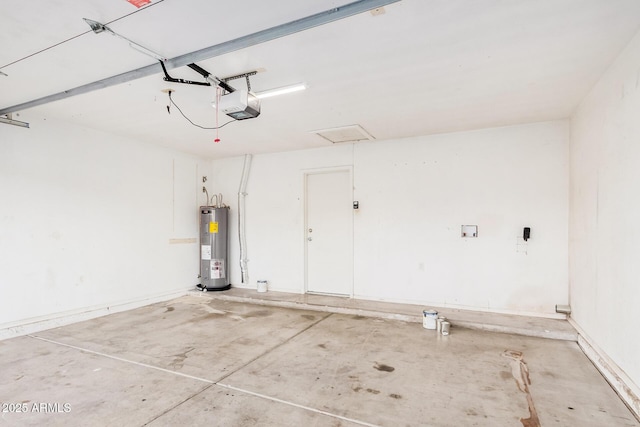 garage featuring electric water heater and a garage door opener