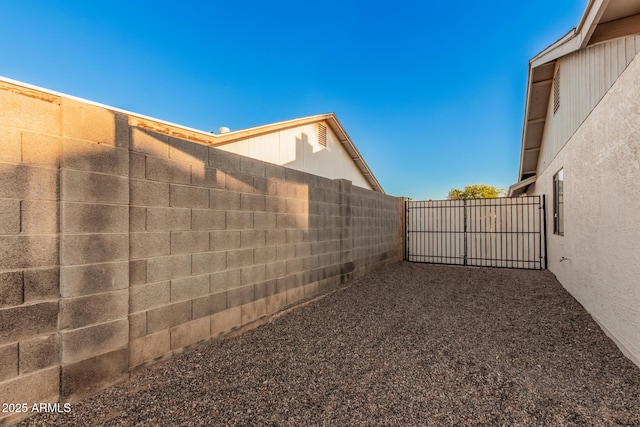 view of yard featuring fence and a gate