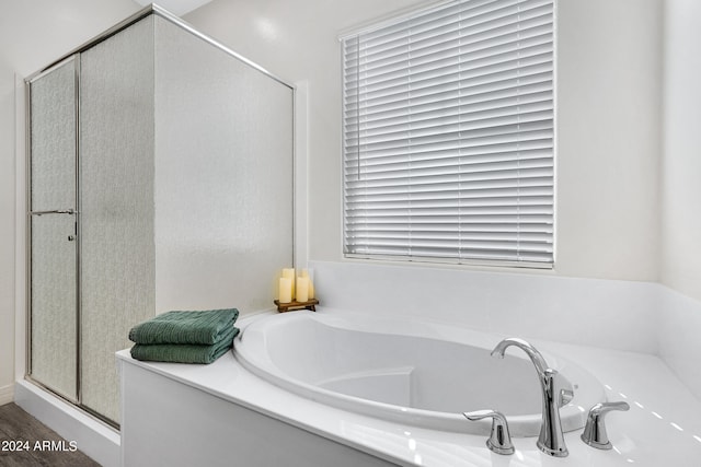 bathroom featuring shower with separate bathtub