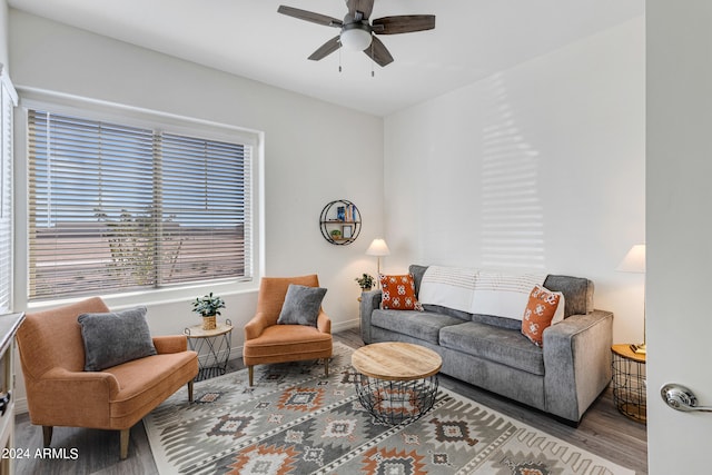 living room with wood-type flooring and ceiling fan