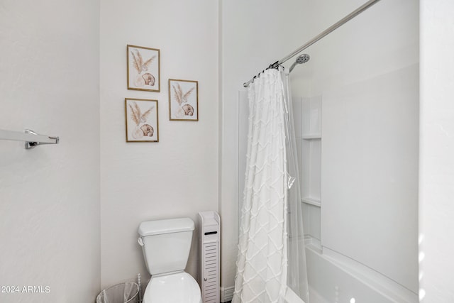 bathroom with shower / bath combination with curtain and toilet