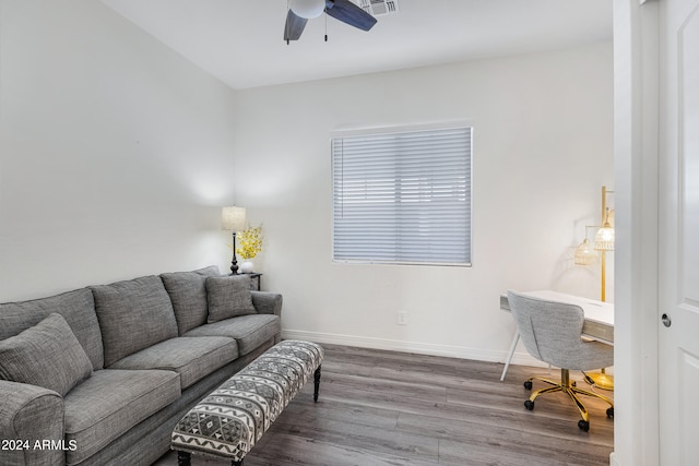 living room featuring ceiling fan and hardwood / wood-style floors