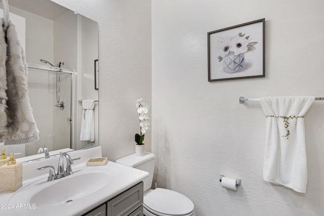 bathroom featuring walk in shower, vanity, and toilet