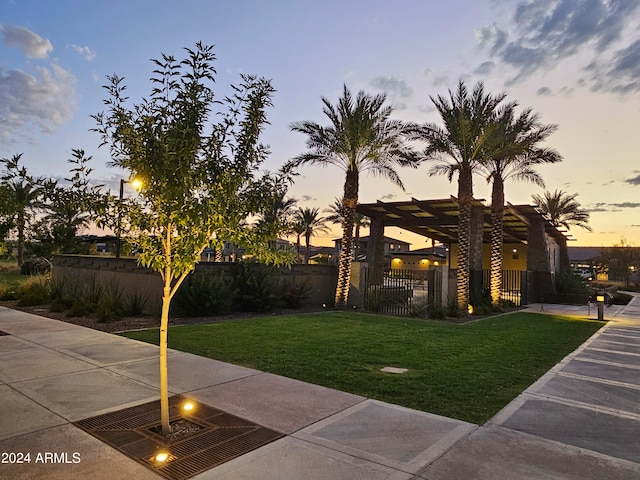 exterior space with a pergola and a lawn