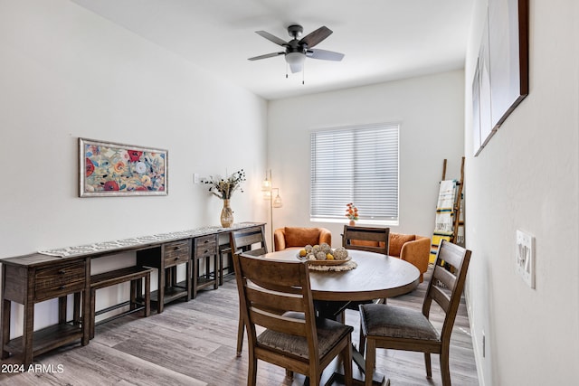 dining space featuring light wood-type flooring and ceiling fan