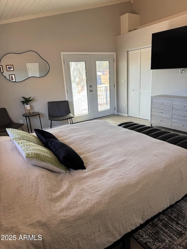 bedroom featuring a closet, access to outside, french doors, and crown molding