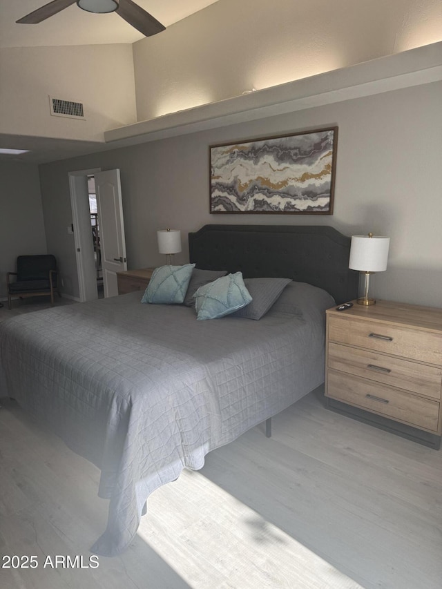 bedroom featuring visible vents, ceiling fan, and light wood-style floors