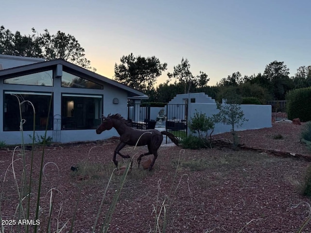 view of yard featuring fence and a sunroom
