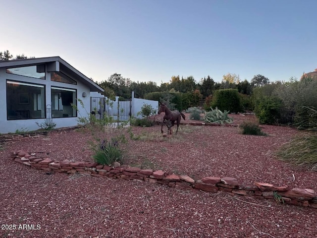 view of yard with fence and a gate