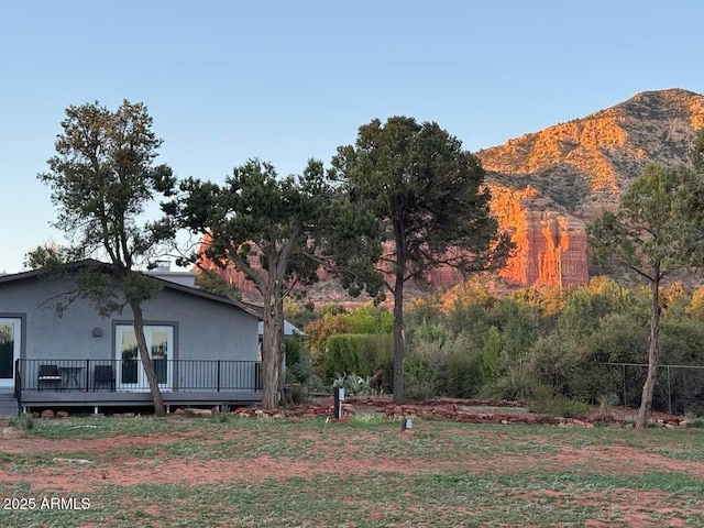 view of yard featuring a deck with mountain view