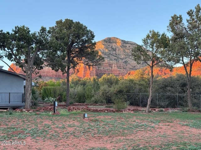 view of yard with a mountain view and fence